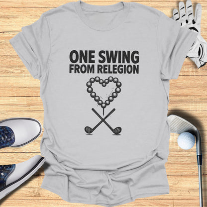 Gray t-shirt with "ONE SWING FROM RELEGION" and golf ball heart design.