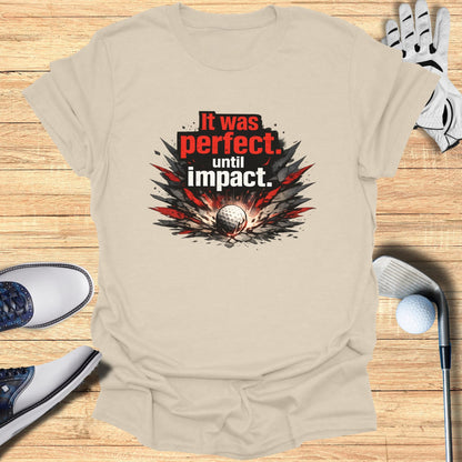 T-shirt with "It was perfect, until impact." text and golf imagery.