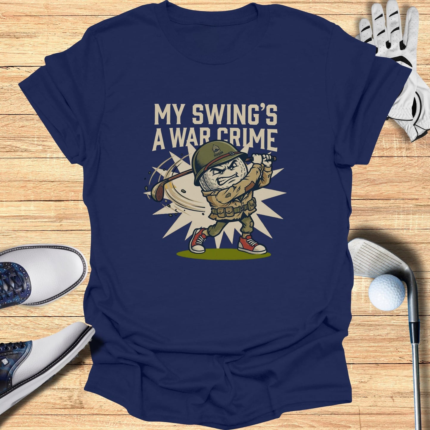 T-shirt graphic of a cartoon soldier swinging a golf club with text "MY SWING'S A WAR CRIME".