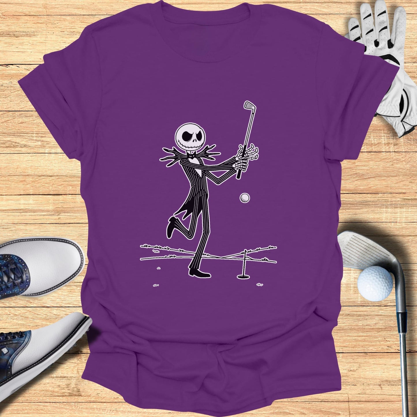 Purple t-shirt with a cartoon of Jack Skellington swinging a golf club.