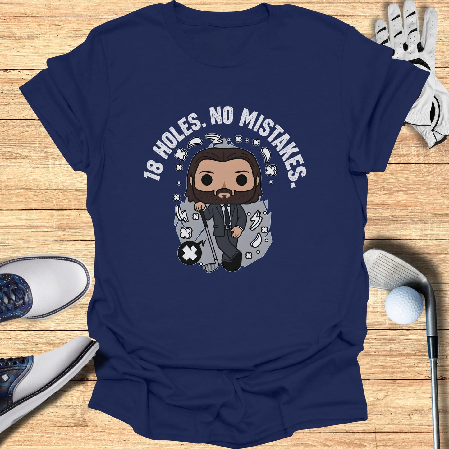 Navy t-shirt with cartoon man, golf clubs, and text "18 HOLES. NO MISTAKES."