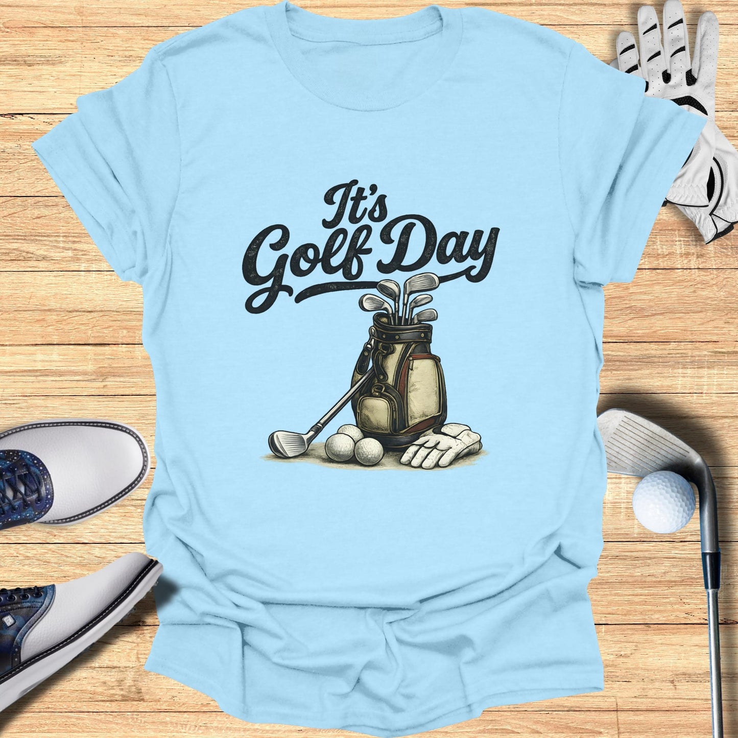 Light blue t-shirt with "It's Golf Day" and golf bag illustration.