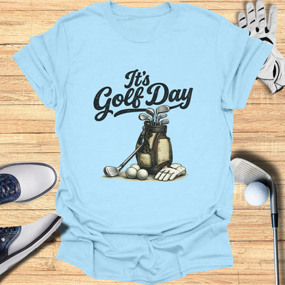 Light blue t-shirt with "It's Golf Day" and golf bag illustration.