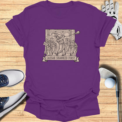 T-shirt with a graphic of Caesar playing golf and the text "CAESAR SHANKED FIRST".