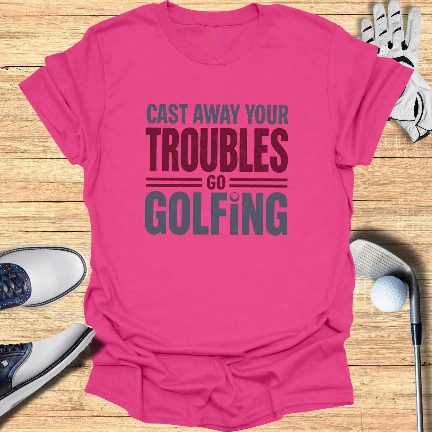 Pink t-shirt with "Cast Away Your Troubles Go Golfing" text.