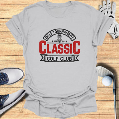 Grey t-shirt with "Golf Tournament Classic Golf Club" text and crest logo.