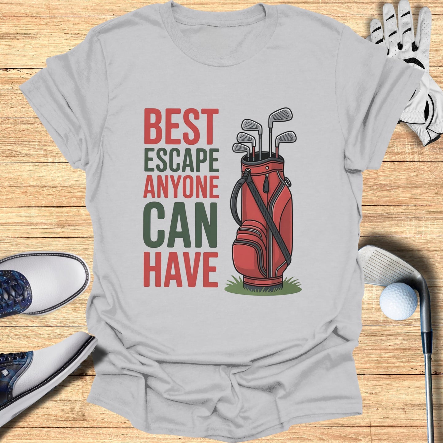 T-shirt with text "BEST ESCAPE ANYONE CAN HAVE" and golf bag graphic.