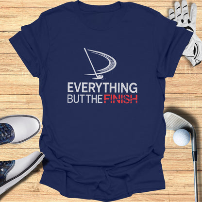 Navy t-shirt with white and red "EVERYTHING BUT THE FINISH" golf design.