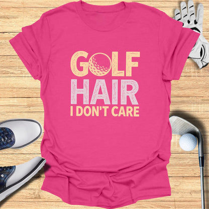 Pink t-shirt with "GOLF HAIR I DON'T CARE" text and golf ball graphic.
