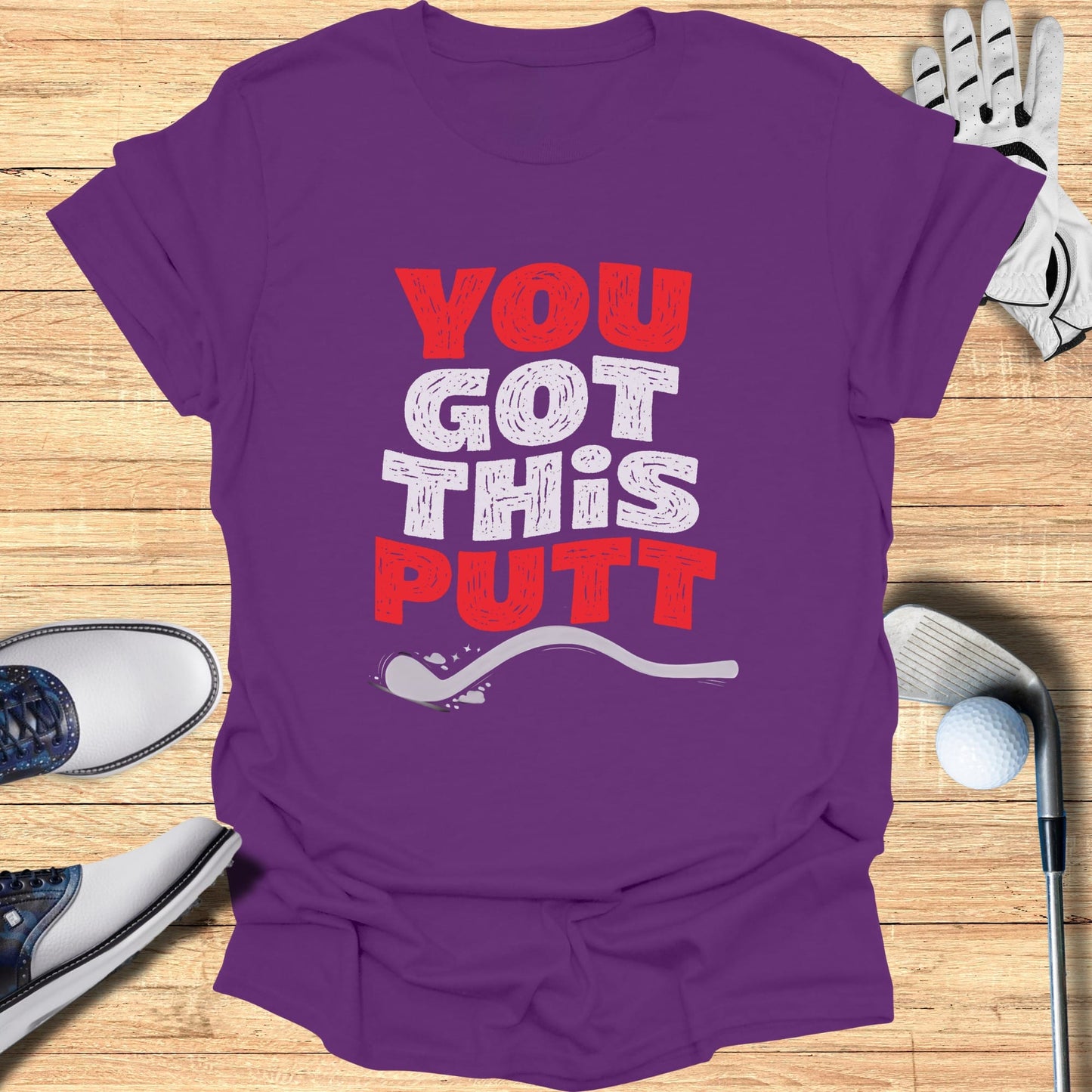 Purple t-shirt with "You Got This Putt" text and golf accessories.