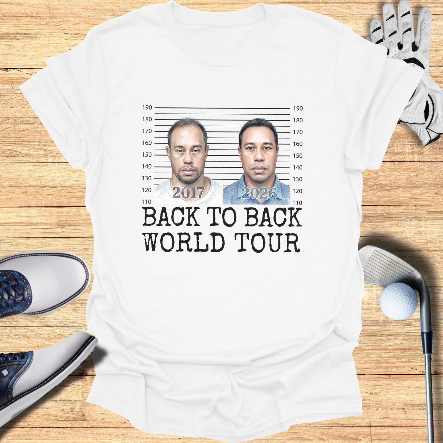 White t-shirt with mugshot-style graphics of Tiger Woods and "2017 2026 BACK TO BACK WORLD TOUR."