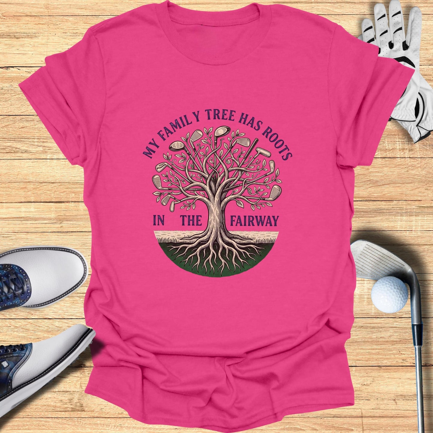 Pink t-shirt with "My family tree has roots in the fairway" golf graphic.