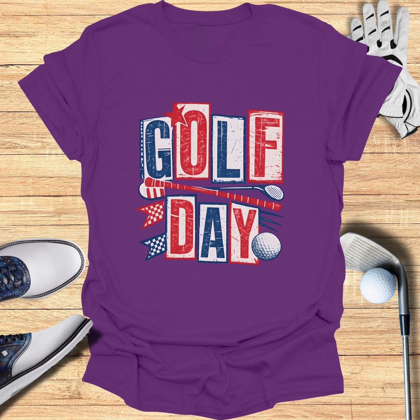 Purple t-shirt with "GOLF DAY" in red, white, and blue block letters and golf accessories.