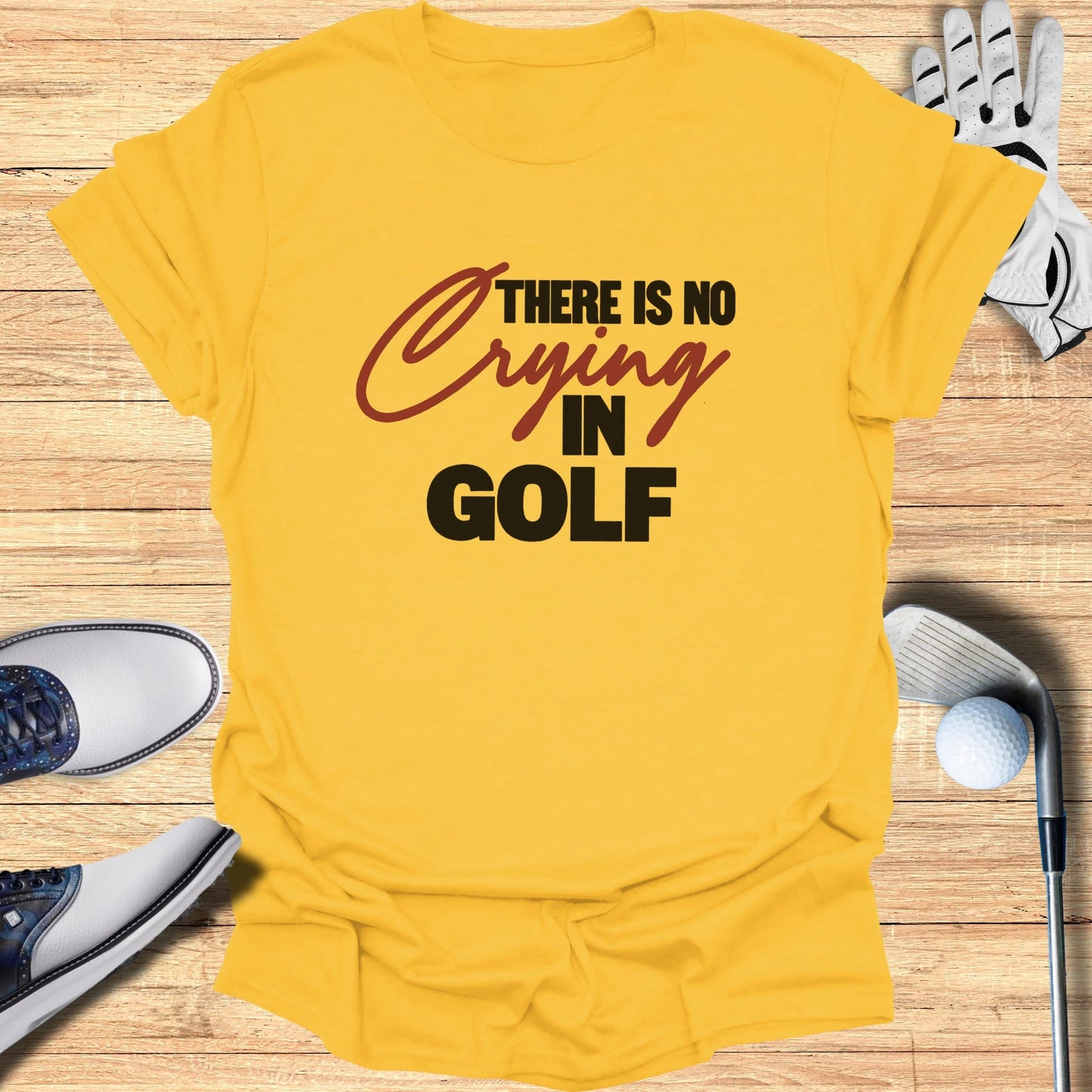 Yellow t-shirt with "THERE IS NO CRYING IN GOLF" text.