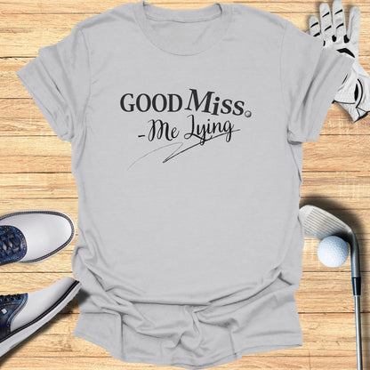 Light gray t-shirt with "GOOD Miss. -Me Lying" text and golf accessories.