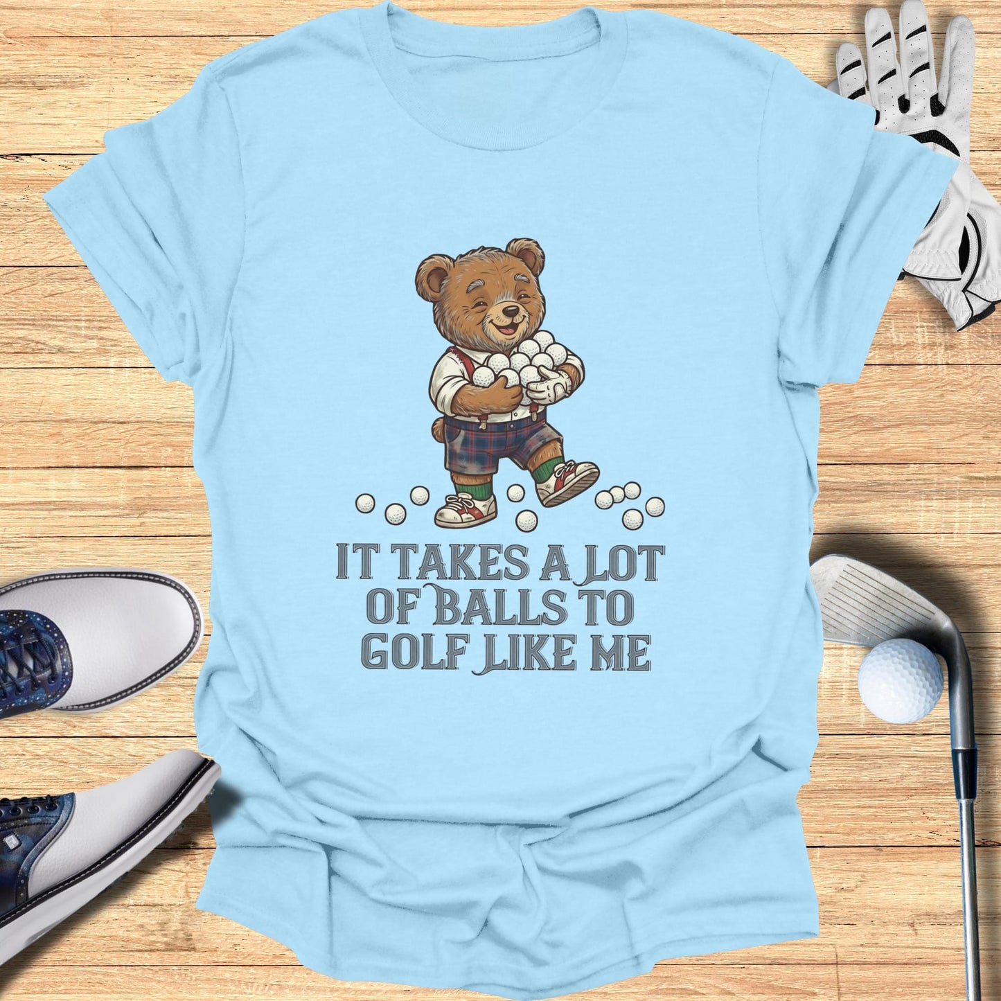 Light blue t-shirt with a cartoon bear holding golf balls and text.