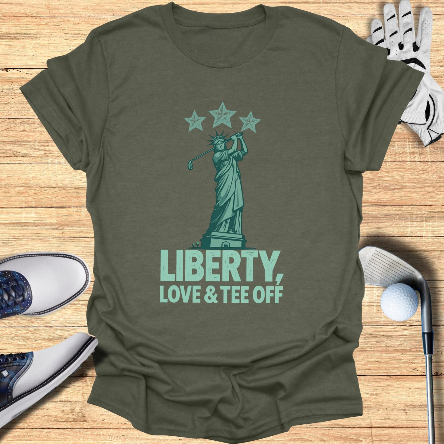 Statue of Liberty swinging a golf club with "Liberty, Love & Tee Off" text.