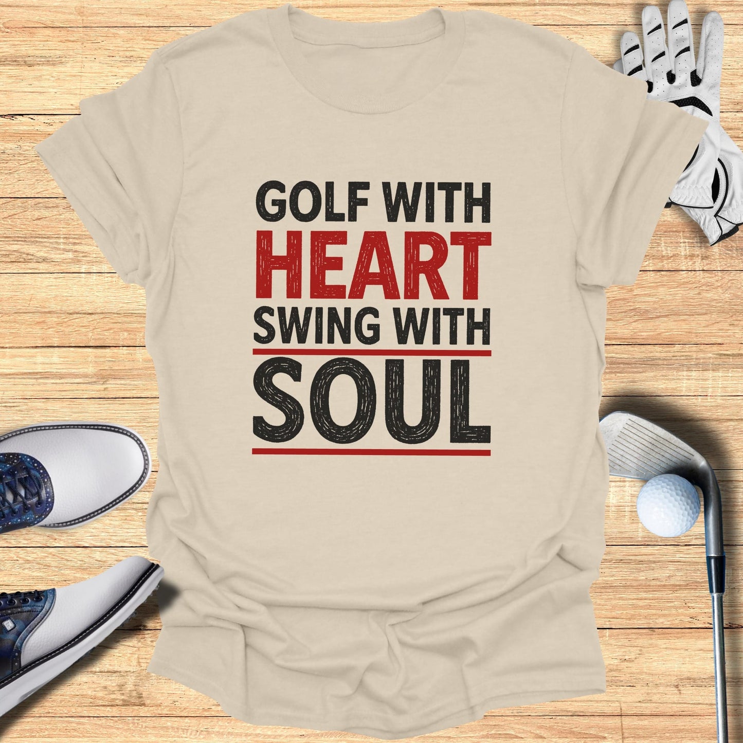 Beige t-shirt with "GOLF WITH HEART SWING WITH SOUL" text and golf accessories.