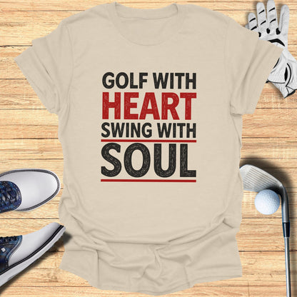 Beige t-shirt with "GOLF WITH HEART SWING WITH SOUL" text and golf accessories.