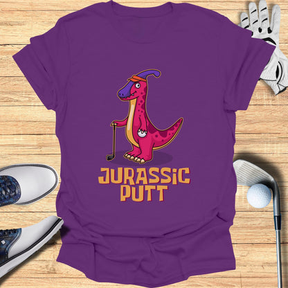 Purple t-shirt with cartoon dinosaur playing golf, text "Jurassic Putt".
