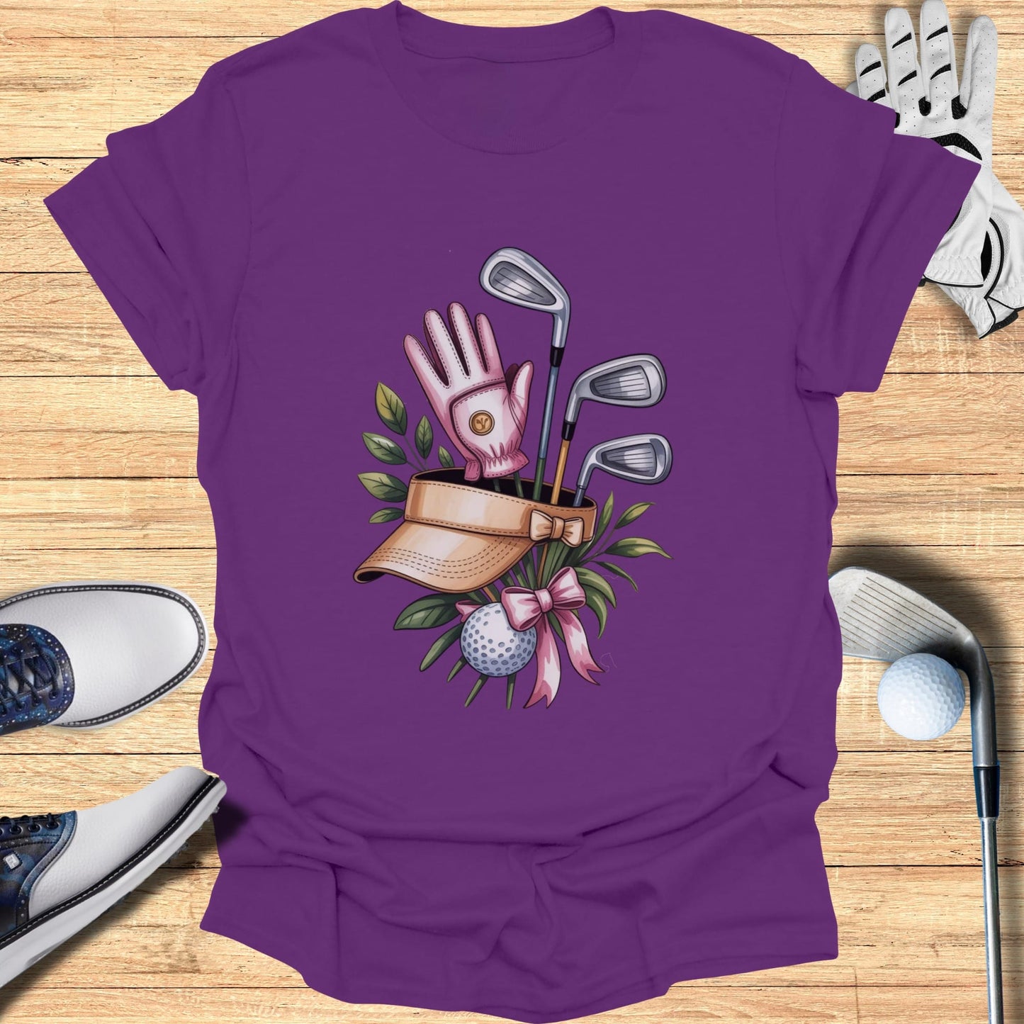 Purple t-shirt with golf club, ball, glove, and visor graphic.