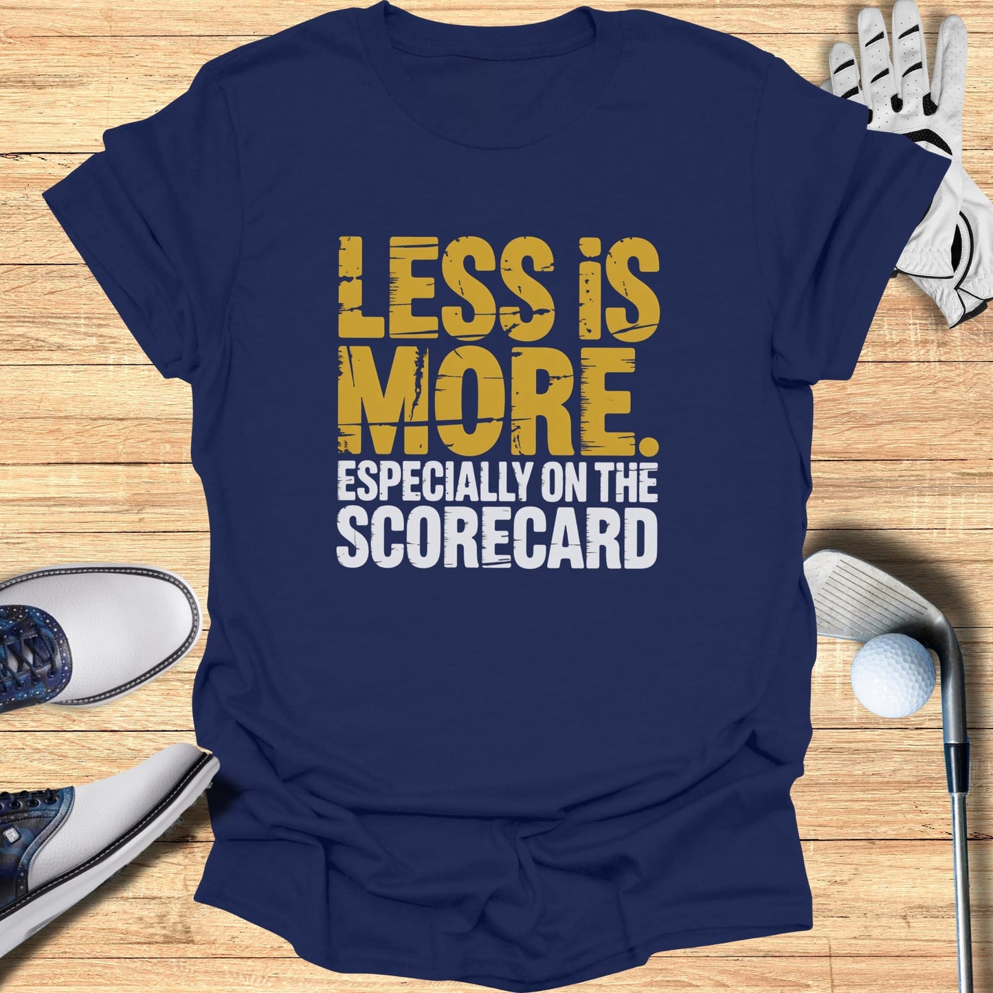 Navy t-shirt with "LESS IS MORE ESPECIALLY ON THE SCORECARD" text.