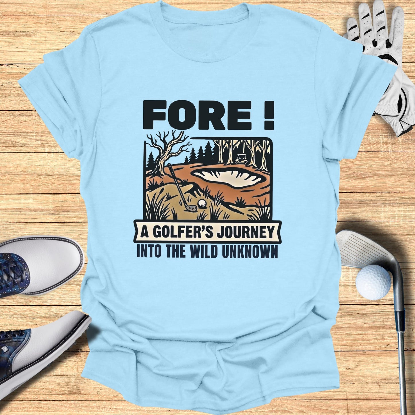 Light blue t-shirt with "Fore! A Golfer's Journey Into The Wild Unknown" text and golf scene.