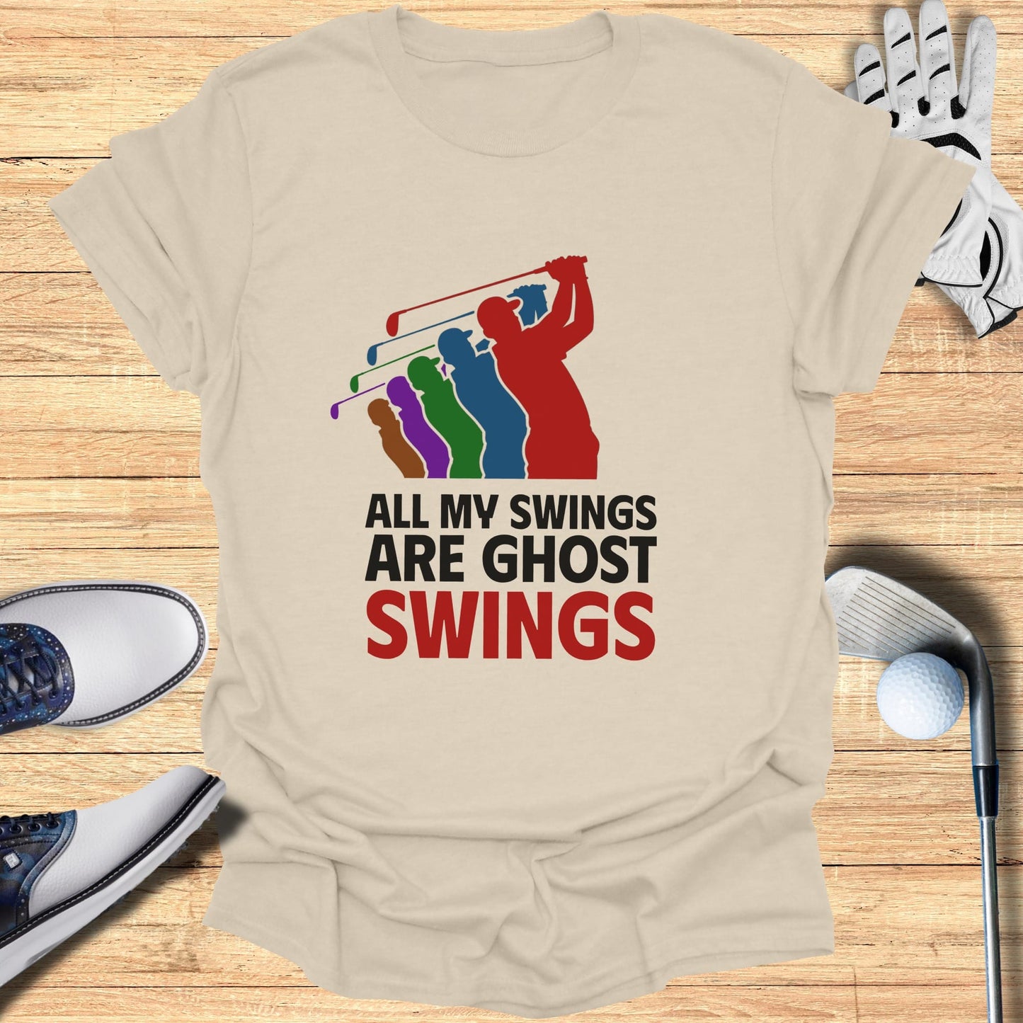 Cream t-shirt with graphic of golfer and text "ALL MY SWINGS ARE GHOST SWINGS".