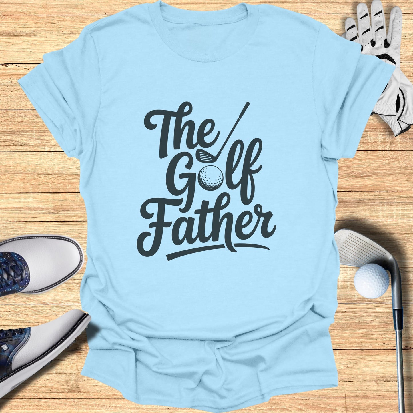 Light blue t-shirt with "The Golf Father" text and golf accessories.