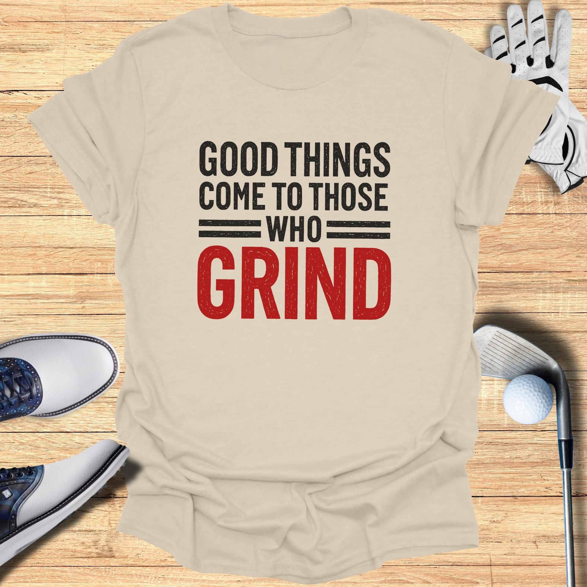 T-shirt with "Good Things Come to Those Who Grind" text, golf clubs, and shoes.