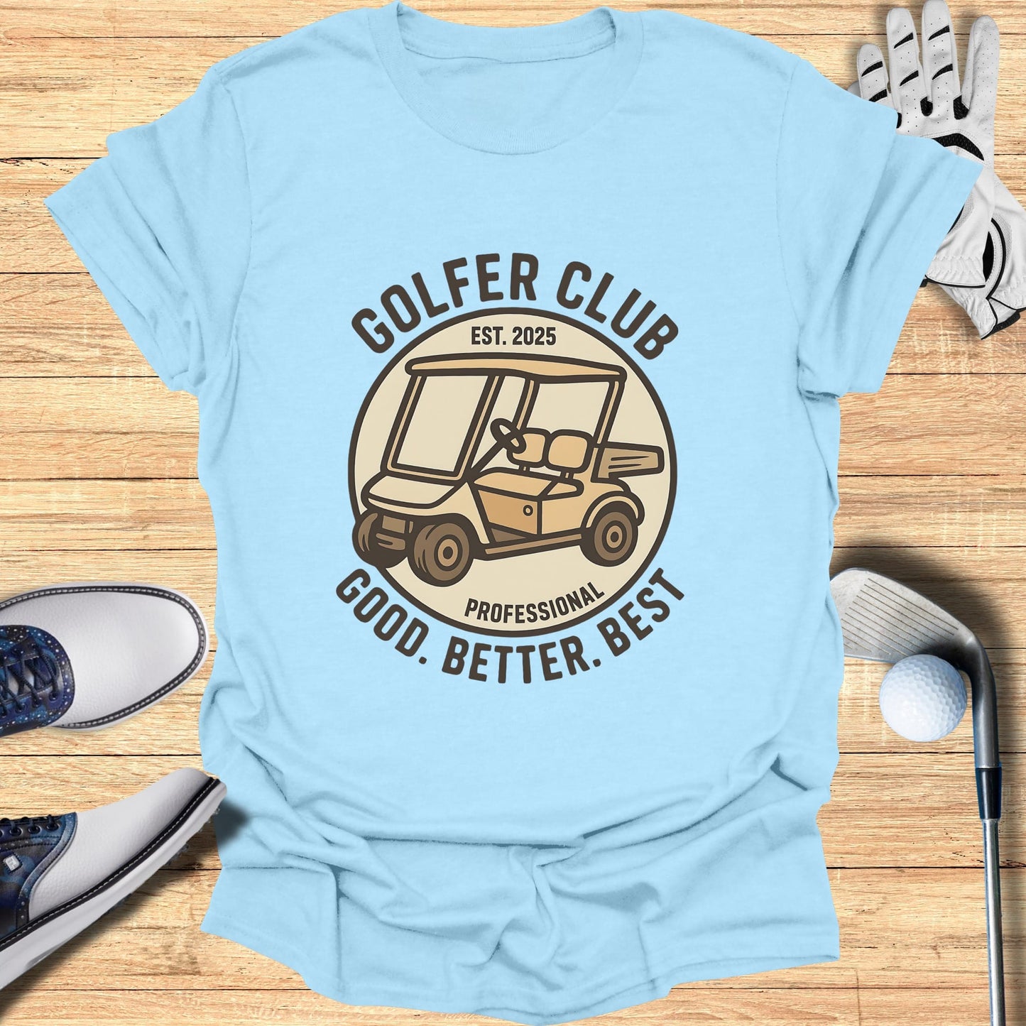 Light blue t-shirt with "GOLFER CLUB EST. 2025 GOOD. BETTER. BEST." and golf cart graphic.