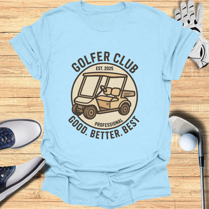 Light blue t-shirt with "GOLFER CLUB EST. 2025 GOOD. BETTER. BEST." and golf cart graphic.