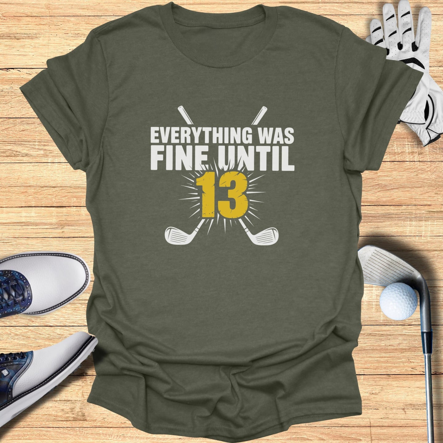 Olive green t-shirt with "Everything Was Fine Until 13" and crossed golf clubs.