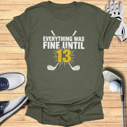 Olive green t-shirt with "Everything Was Fine Until 13" and crossed golf clubs.