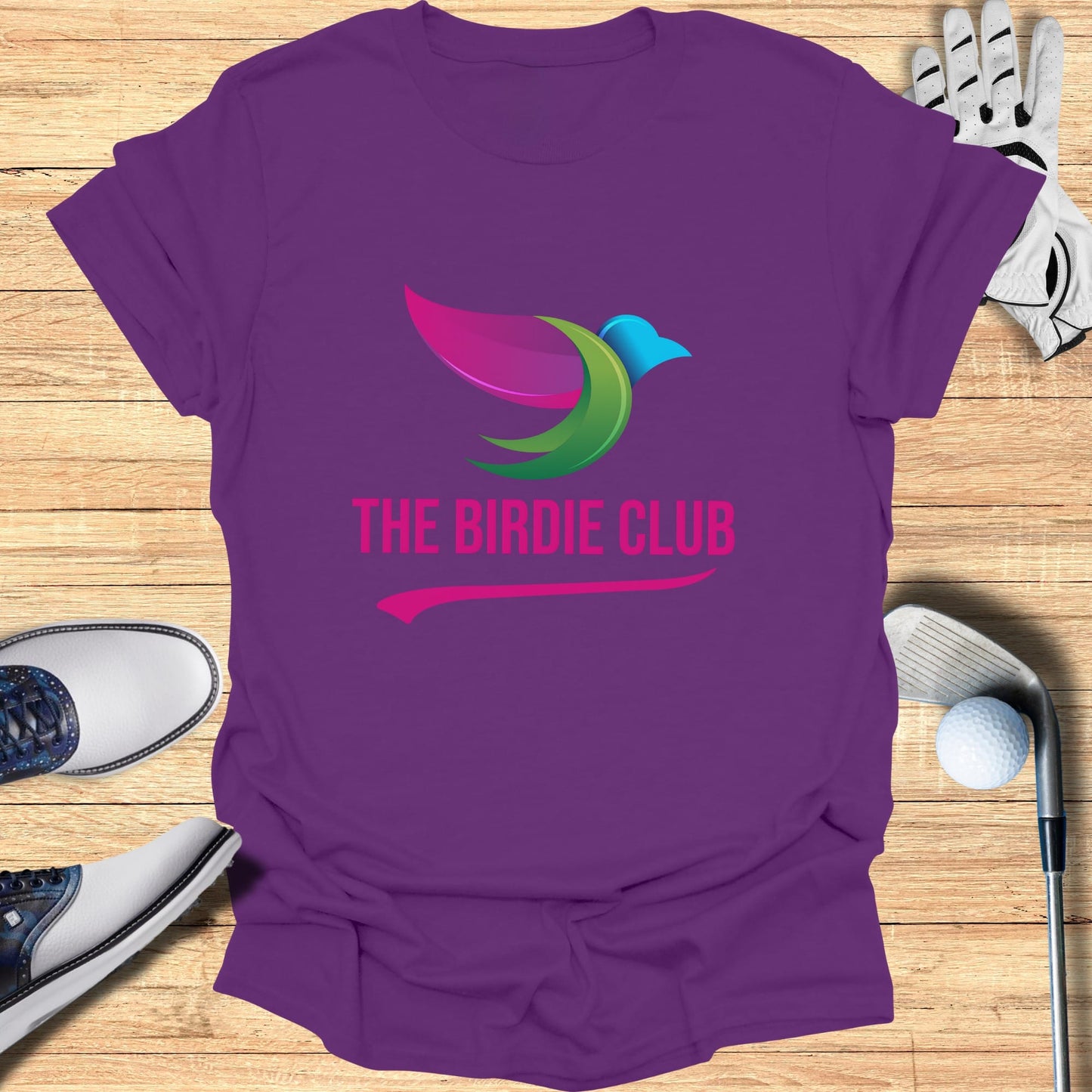Purple t-shirt with "The Birdie Club" logo, golf shoes, glove, and ball.
