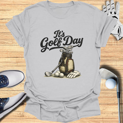 Gray t-shirt with "It's Golf Day" and golf bag, clubs, balls, and gloves.