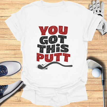 White t-shirt with "YOU GOT THIS PUTT" text and golf accessories.