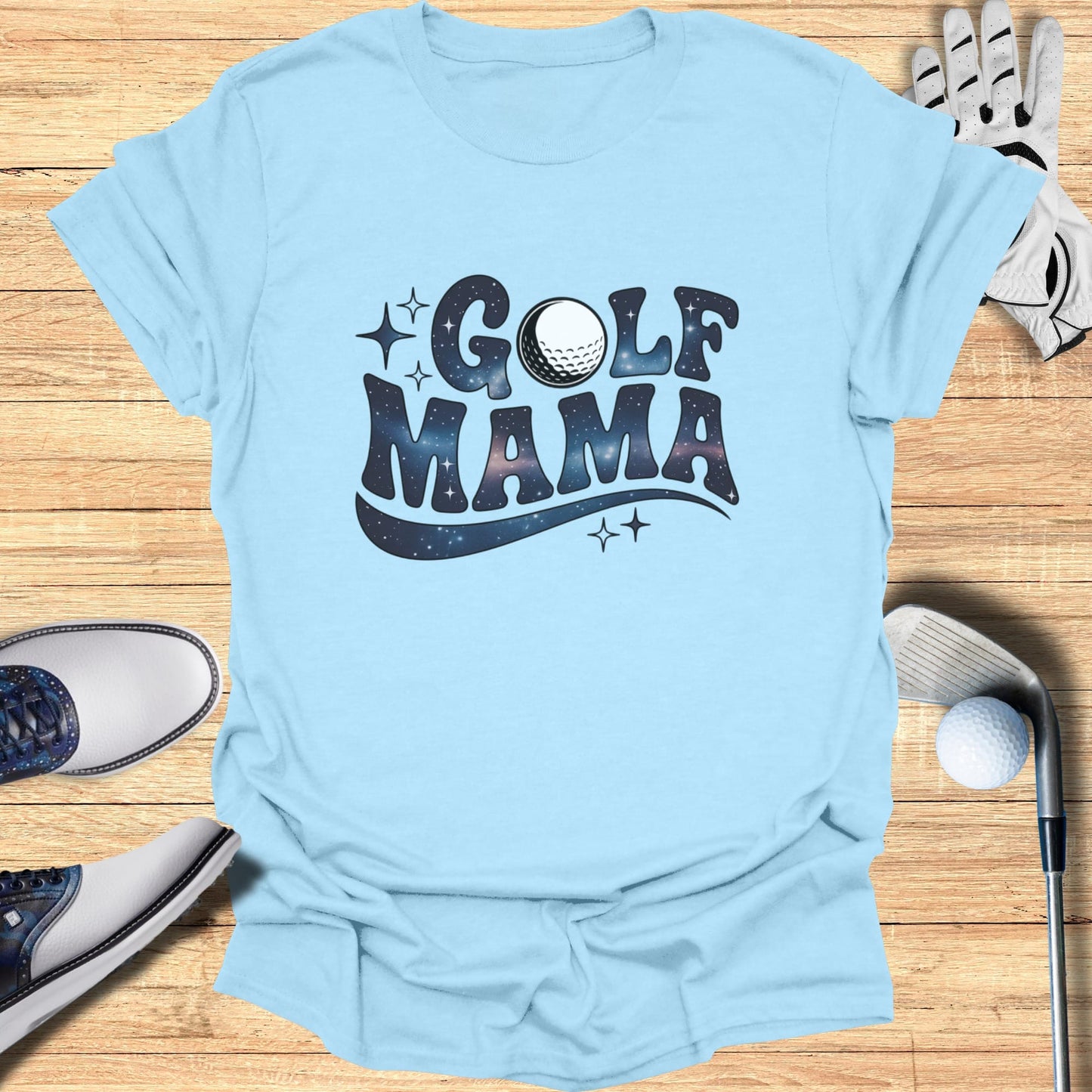 Light blue t-shirt with "GOLF MAMA" in a galaxy font and golf accessories.