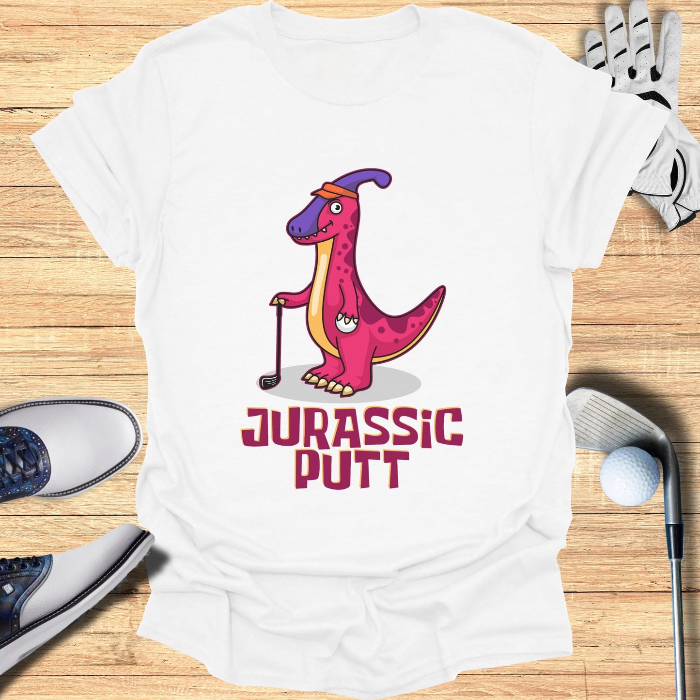 T-shirt with "Jurassic Putt" text and cartoon dinosaur holding golf club.