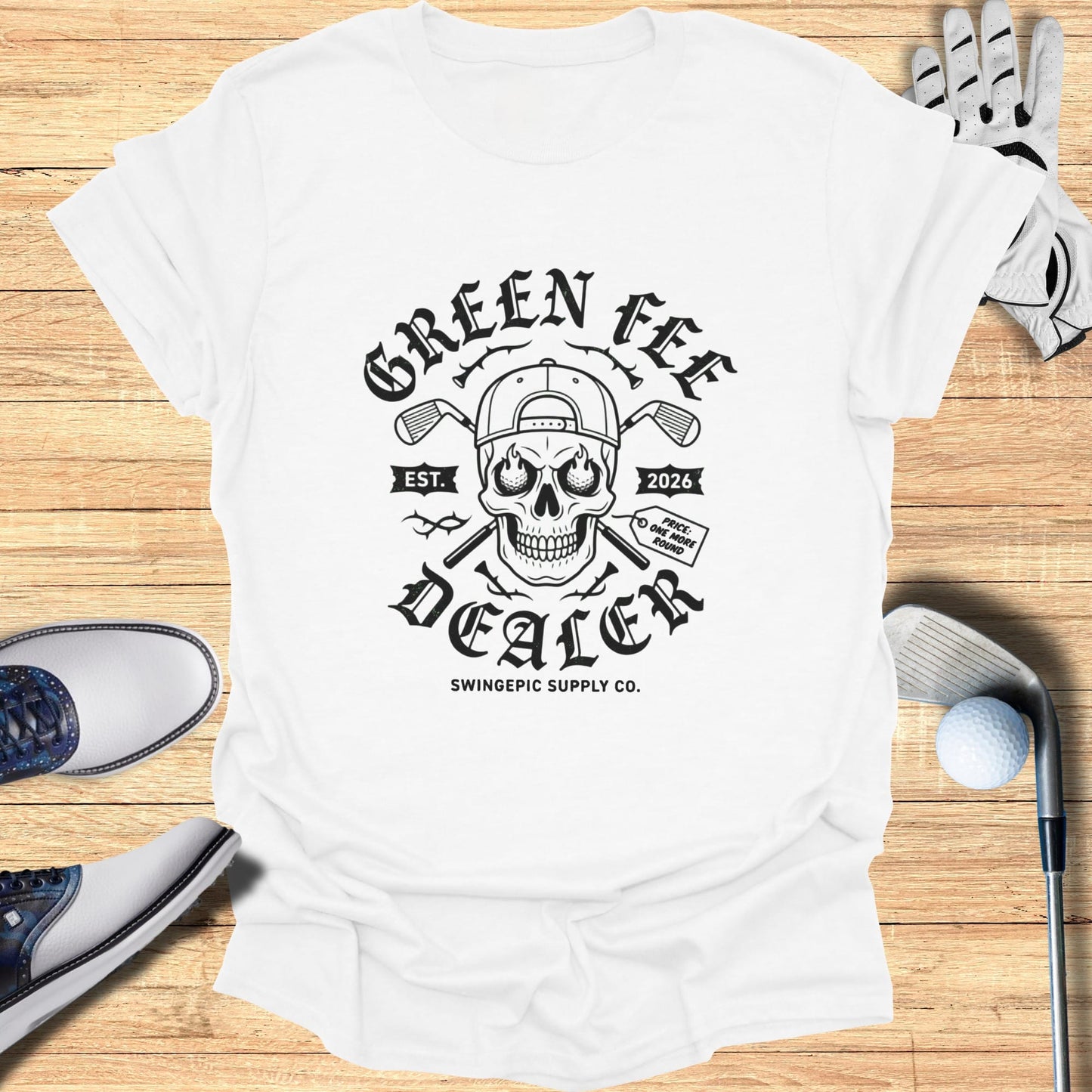 White t-shirt with "Green Fee Dealer" skull graphic and "Swingepic Supply Co." text.