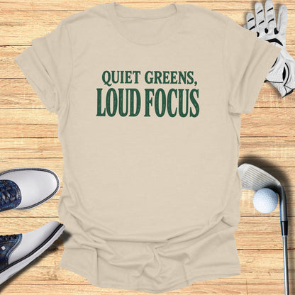 Cream t-shirt with "Quiet Greens, Loud Focus" in green text.