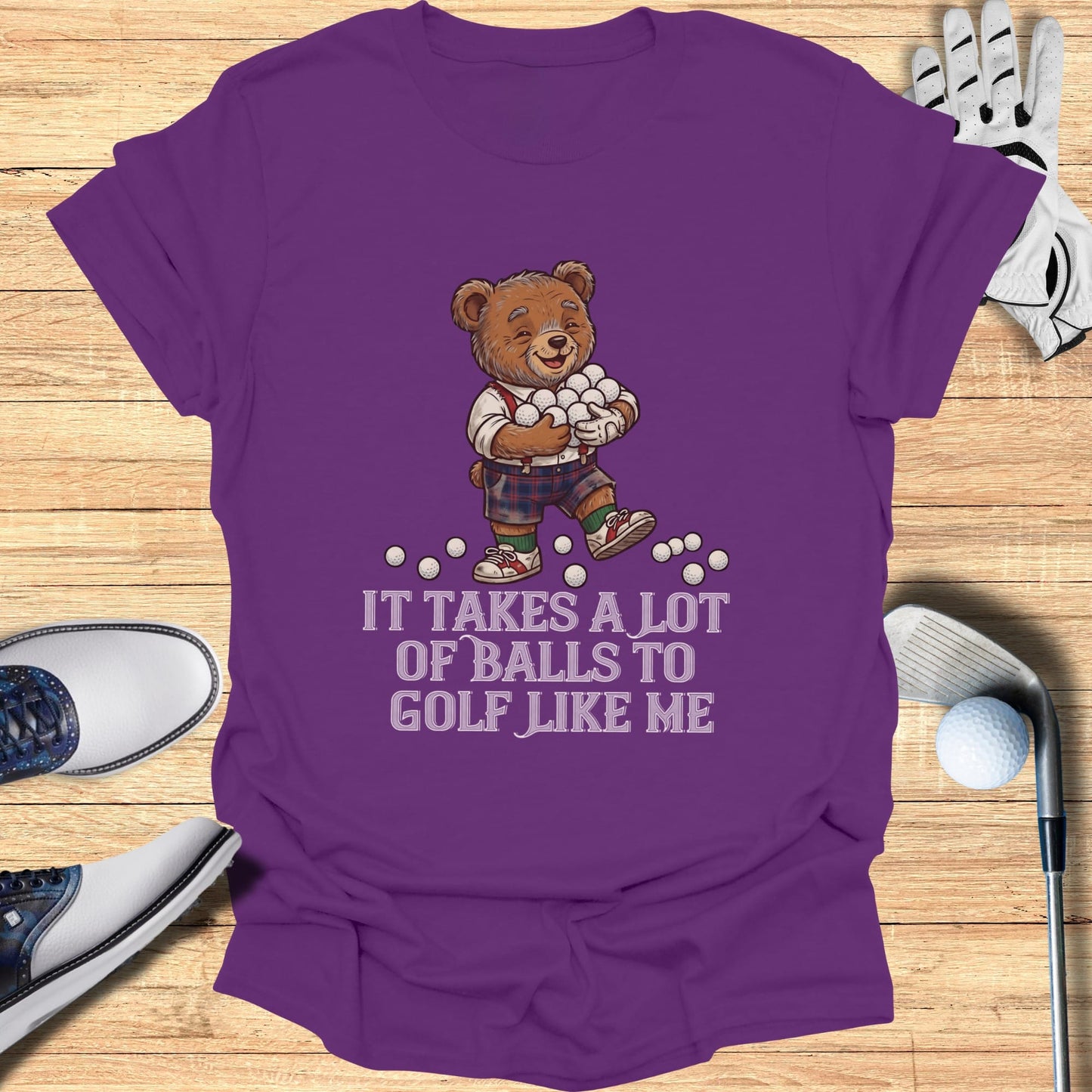 Teddy bear wearing golf attire holding golf balls with text.