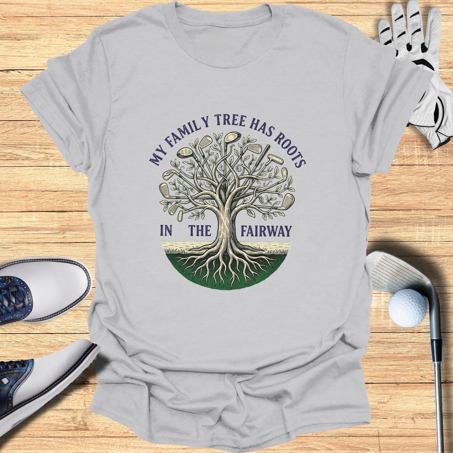 T-shirt with "My family tree has roots in the fairway" golf-themed graphic.