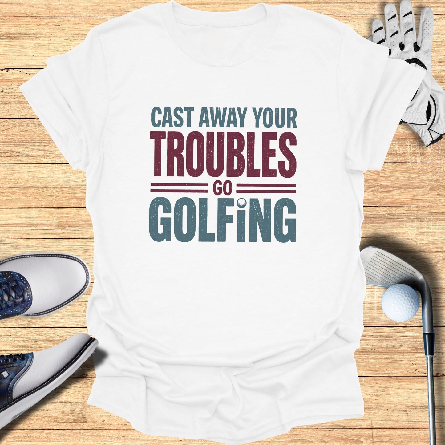 White t-shirt with "Cast Away Your Troubles Go Golfing" text.