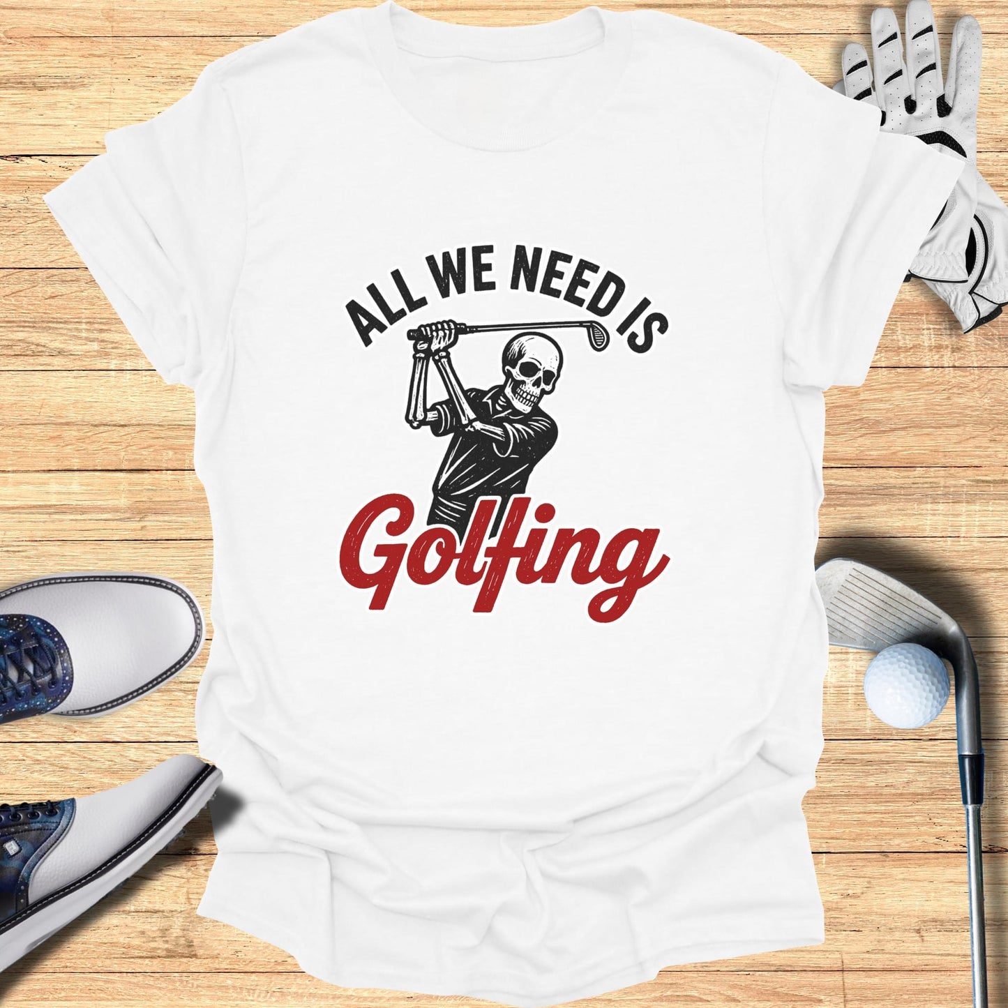 White t-shirt with "All We Need Is Golfing" and skeleton golfer graphic.