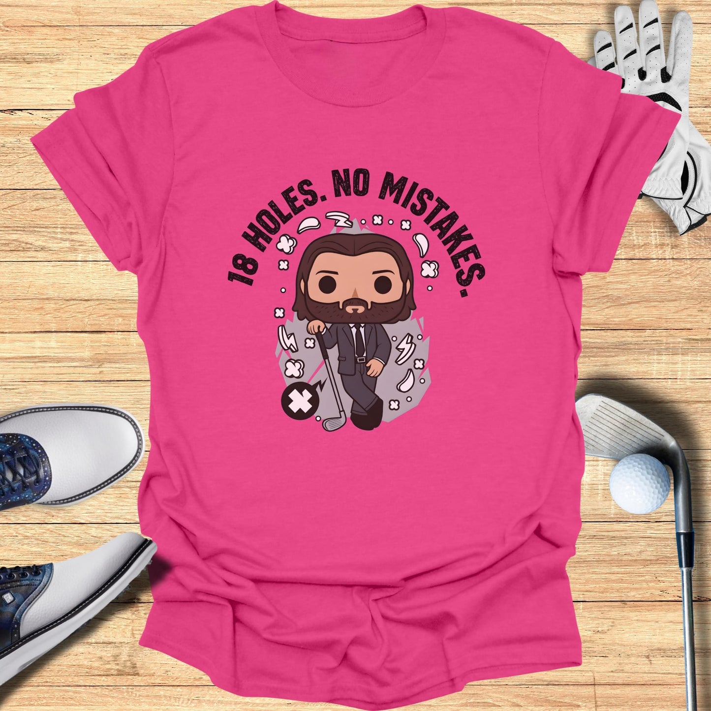 Pink t-shirt with cartoon golfer and text "18 HOLES. NO MISTAKES."