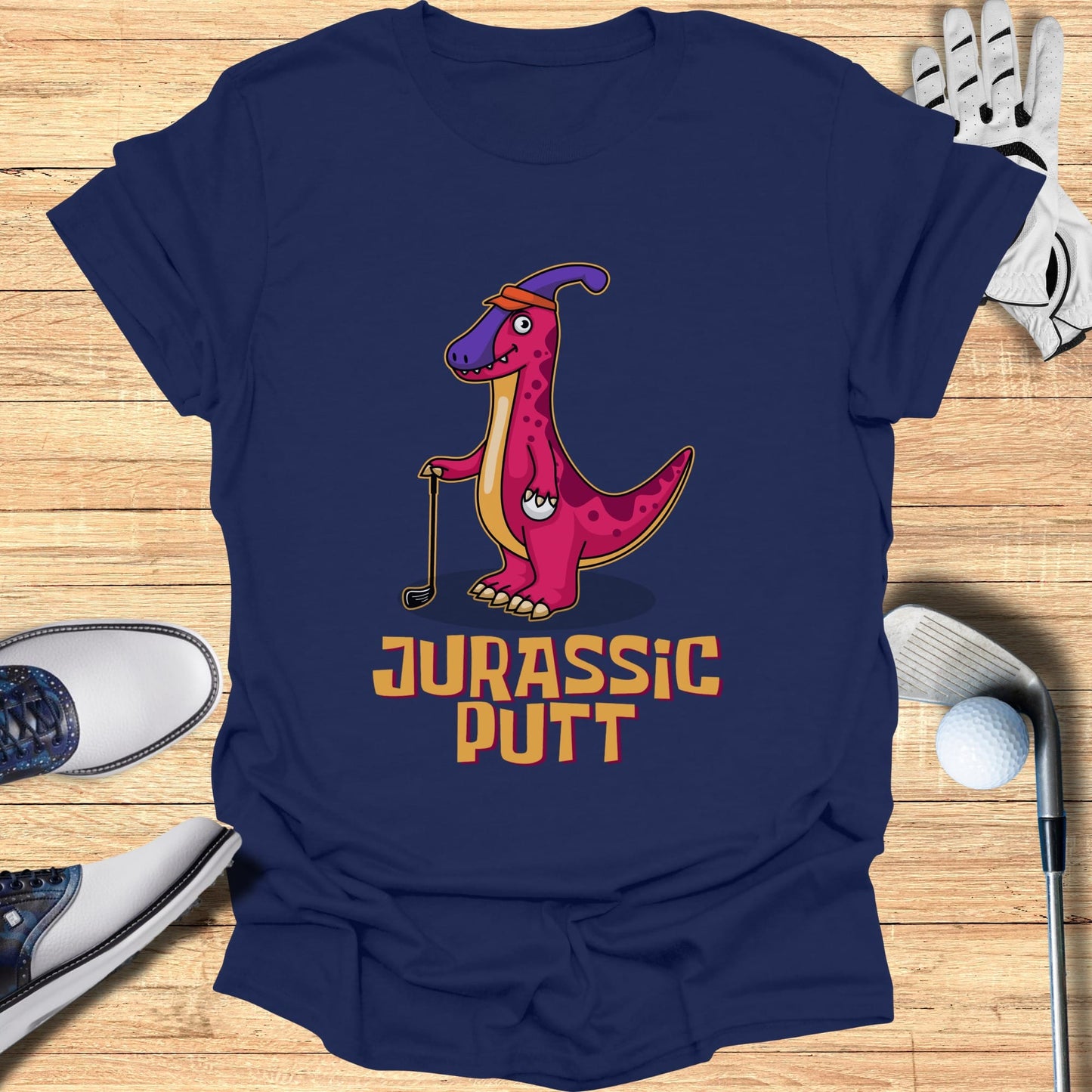 T-shirt with pink dinosaur golfing, "Jurassic Putt" text.