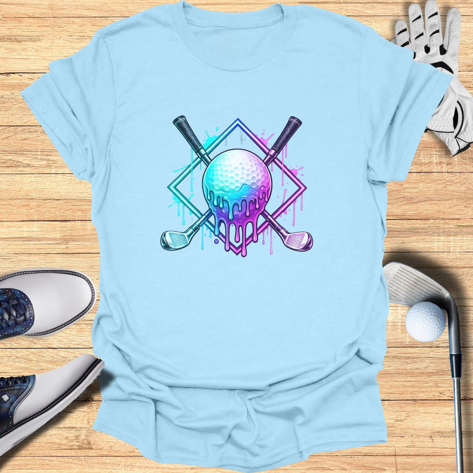 Dripping golf ball and clubs design on a light blue t-shirt.