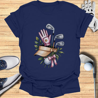 Golf club, glove, visor, ball, and shoes on a wooden surface.
