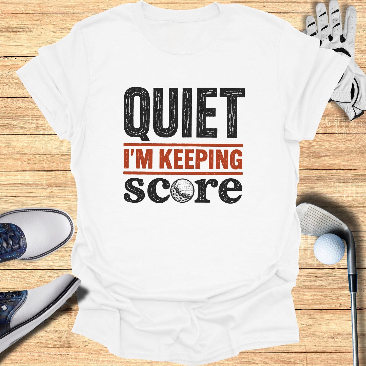 White t-shirt with "QUIET I'M KEEPING SCORE" and golf ball graphic.